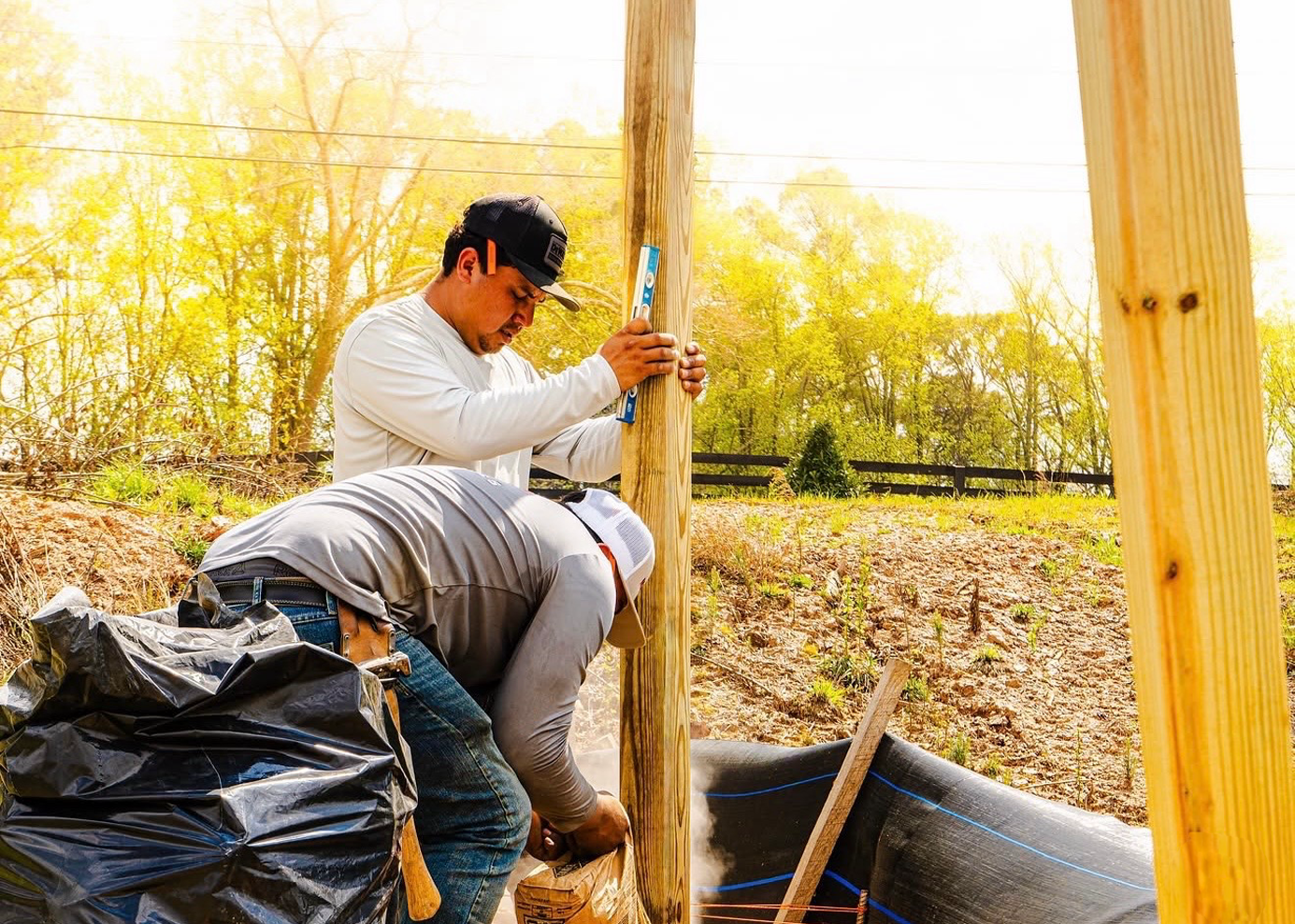 Picket & Post crew setting a fence post on a Charlotte jobsite